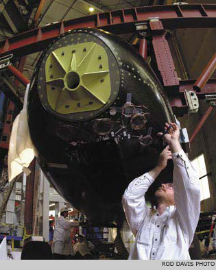 Jerry Newland makes adjustments to composite panels on NASA's X-37