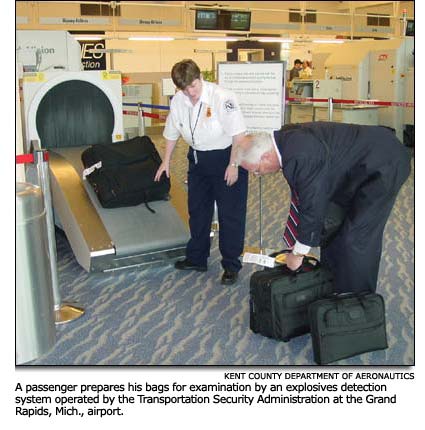 a passenger prepares his bags for explosives examination