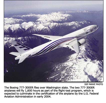 777-300ER flying over Washington state