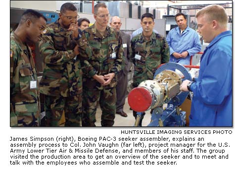 James Simpson explains an assembly process to Col. John Vaughn and members of his staff.