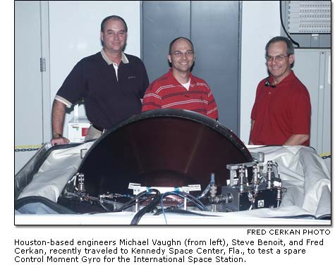 Michael Vaughn, Steve Benoit and Fred Cerkan testing a spare Control Moment Gyro for the International Space Station.