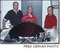 Michael Vaughn, Steve Benoit and Fred Cerkan testing a spare Control Moment Gyro for the International Space Station.