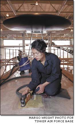 Edith Clemons attacks corrosion on a Boeing E-3 Sentry undergoing depot maintenance