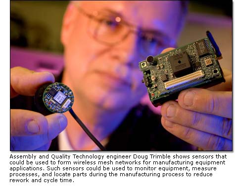 Electrical engineer Sam Easley checks a micromachining station.