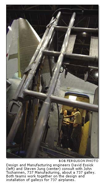 David Essick and Steven Jung consult with John Tschannen about a 737 galley