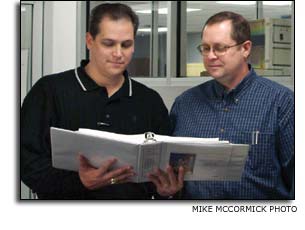 Mike Stokes reviews plans with Robert McGuigan