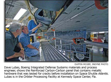 Dave Lubas shows the panel that was tested for cracks before installation on Space Shuttle Atlantis