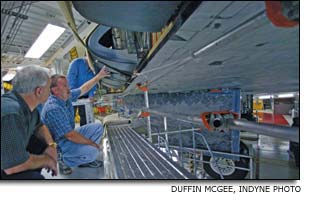 Dave Lubas shows the panel that was tested for cracks before installation on Space Shuttle Atlantis