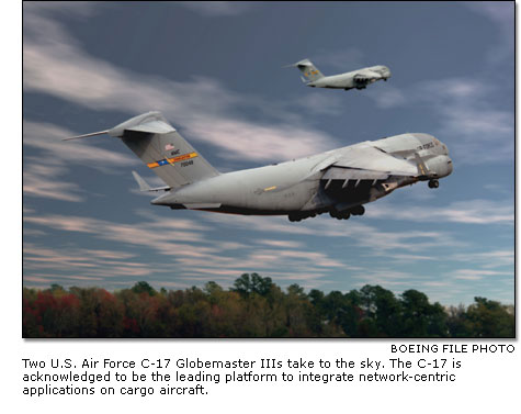Two U.S. Air Force C-17 Globemaster IIIs take to the sky.
