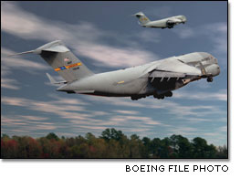 Two U.S. Air Force C-17 Globemaster IIIs take to the sky.