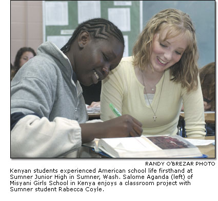 Salome Aganda of Misyani Girls School in Kenya enjoys a classroom project with Sumner Junior High student Rabecca Coyle