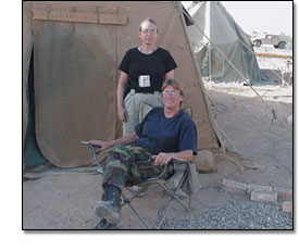 Kathy Crain and Connie Goddard pose in front of their tent in Tikrit, Iraq