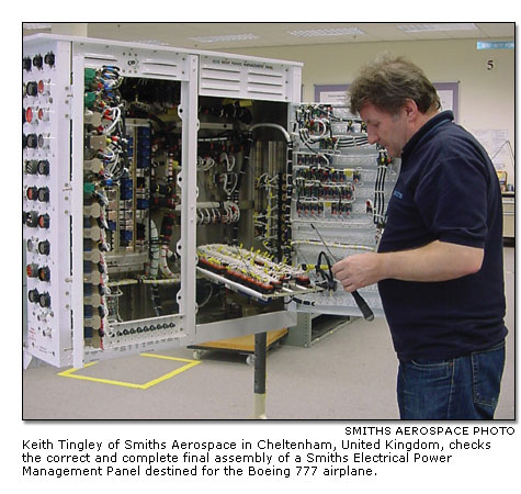Keith Tingley checks the correct and complete final assembly of an Electrical Power Management Panel