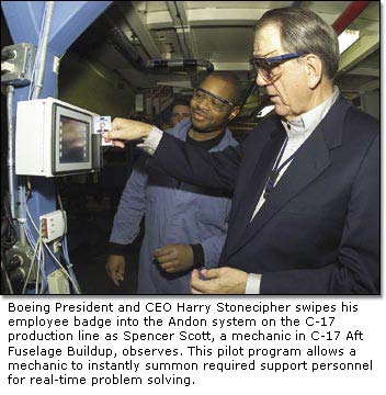 Boeing President and CEO Harry Stonecipher swipes his employee badge into the Andon system on the C-17 production line