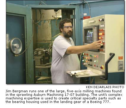 Jim Bergman runs one of the large, five-axis milling machines found in the sprawling Auburn Machining 17-07 building.