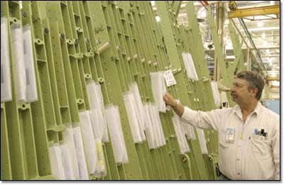 Machining mechanic Bob Brunke checks lattice rail shipsets prior to assembly.