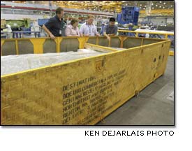 Jim Christopher Debra Kunigonis, Aaron Kotyluk and Tom Kato examine a 737 vertical fin built in China and packed for shipping in a bamboo crate.