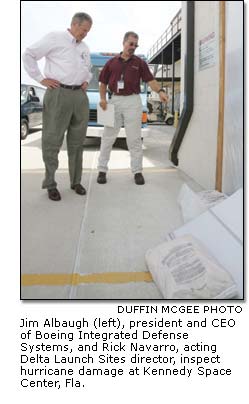 Jim Albaugh and Rick Navarro inspect hurricane damage at Kennedy Space Center, Fla.