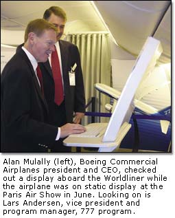 Alan Mulally checks out a display aboard the Worldliner.