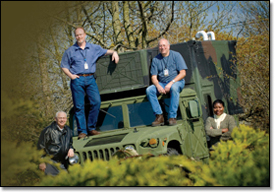 Michael Pounds (from left), Douglas Fitchitt,
Richard Bowers and Sara Jean Olimb surround a Humvee that uses the Connexion by Boeing service.