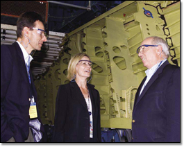 Howard Chambers (right) vices president, Program Management and Independent Review, chats with program managers Bob Ciesla and Nan Bouchard