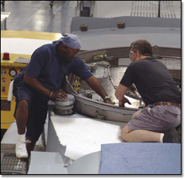 Eric Wimberly (left) and Bob Daviduk work on V-22