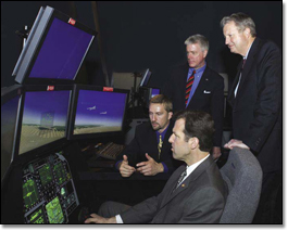 Jim Albaugh participates in a demonstration of the new Virtual Warfare Center=