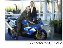 Qatar Airways CEO Akbar Al Baker on a  Kawasaki Dreamliner sportbike with Alan Mulally standing by