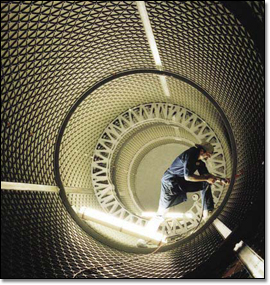 A technician performs work on a Delta II first stage booster