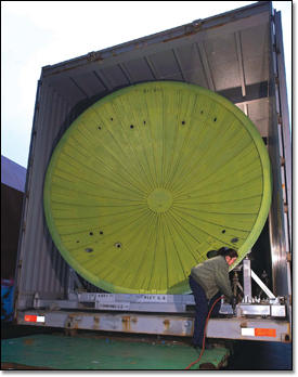 Diane Kaufman prepares to remove a pressure dome and tail cone for a Boeing 777 from
an oversized cargo container