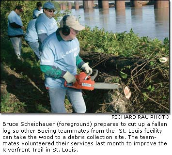 Bruce Scheidhauer (foreground) prepares to cut up a fallen log 