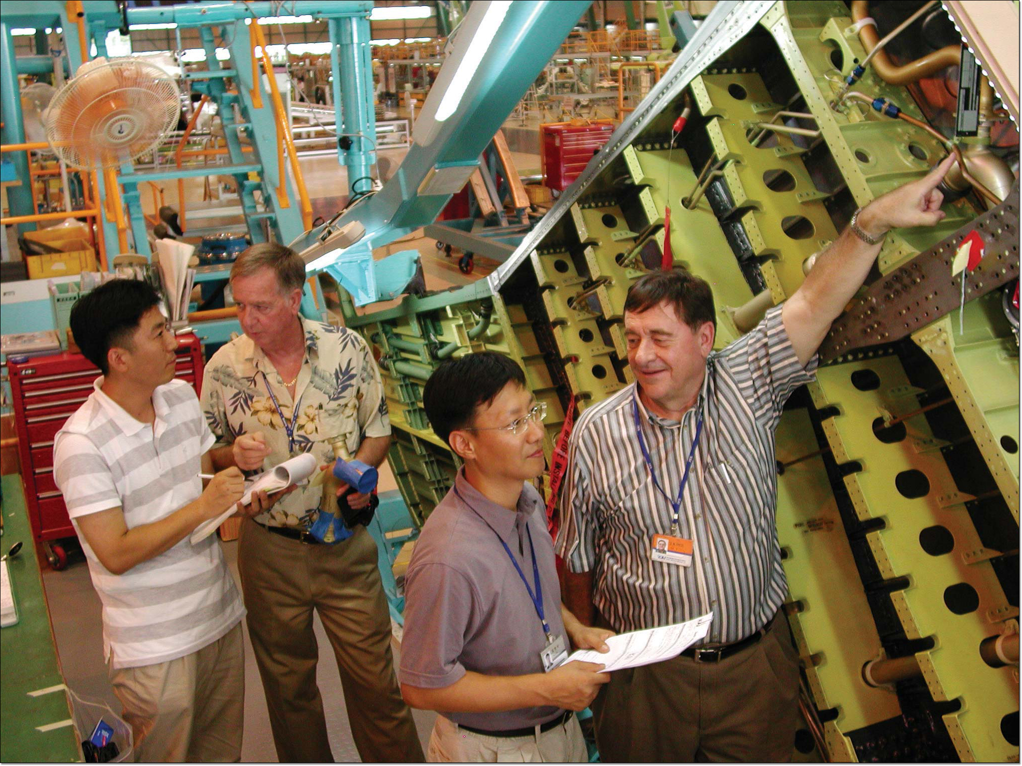 Boeing Korea employees look at fuel system in the F-15K