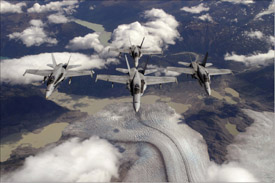 Four U.S. Navy F/A-18 aircraft fly in formation