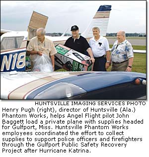 Henry Pugh helps Angel Flight pilot John Bagget load a private plane with supplies