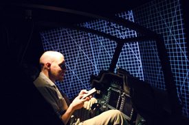 Kenneth Long works inside an Apache Longbow Crew Trainer