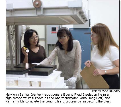 MaryAnn Santos, Vann Heng and Karrie Hinkle complete the coating firing process by inspecting the tiles