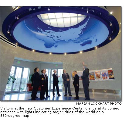 Visitors at the new Customer Experience Center glance at its domed entrance