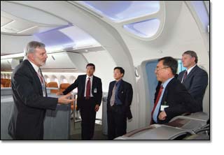 Korean Air and Boeing representatives tour the Boeing 787 mockup at the new Customer Experience Center