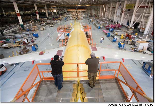 Bennie Johnson and Rodrigo Mesquita reflect on the final Boeing 717 as it enters the moving assembly line