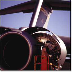 Scott Kober, a technician on the C-17 program, works on an airlifter's engine on the ramp in Long Beach, Calif.