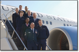 Standing outside the C-32A are crew members of the U.S. Air Force's 89th Airlift Wing.